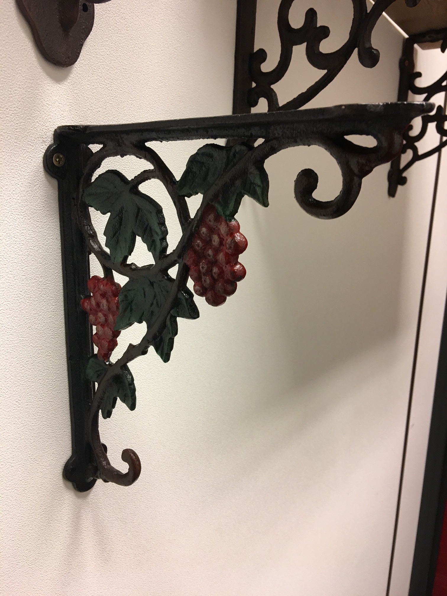 Beautiful shelf hanger with grape motif, cast iron-small