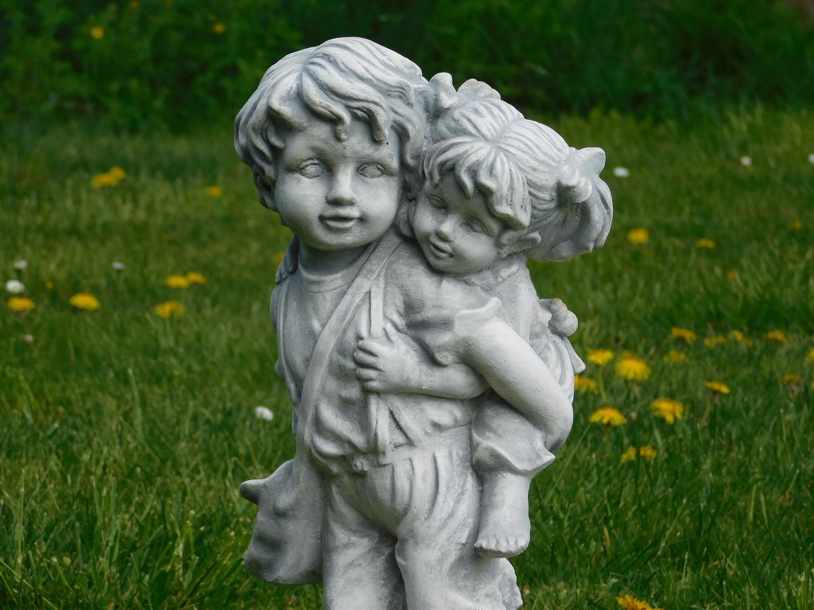 Statue of brother and sister - solid stone