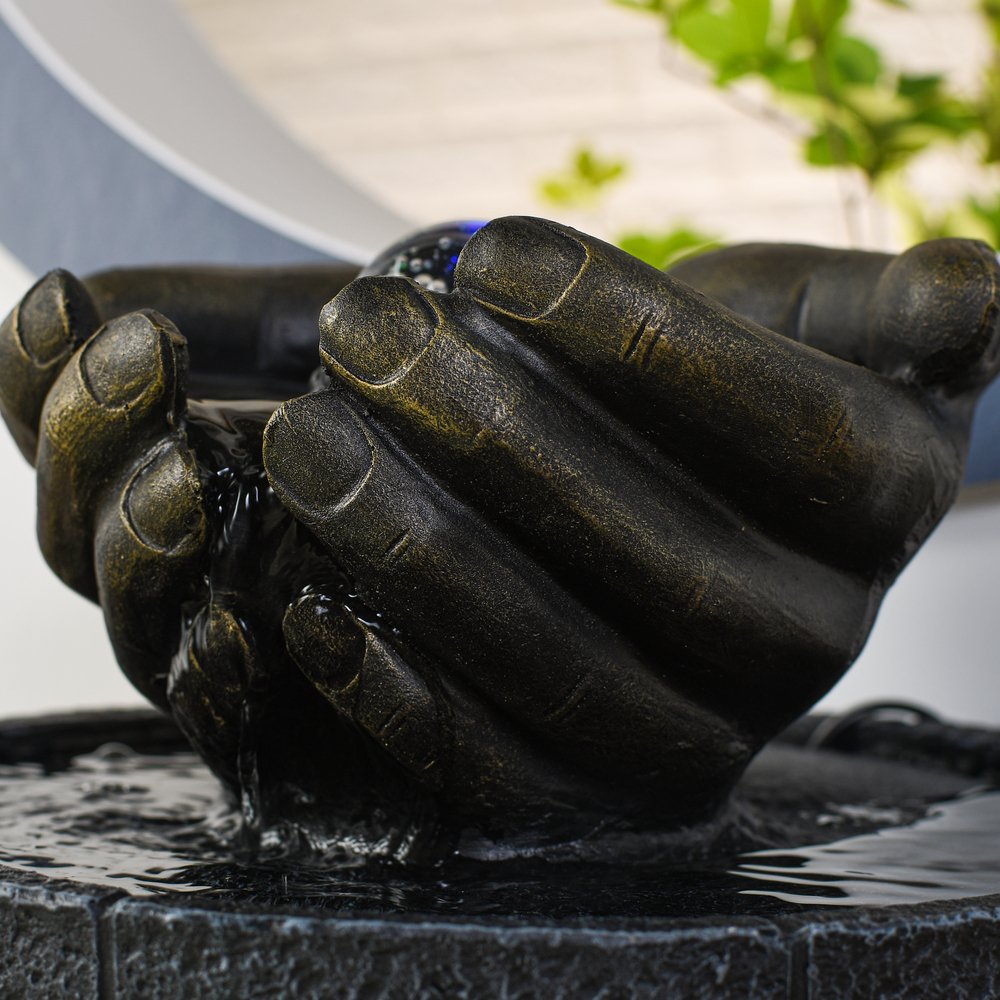 Indoor fountain, hands as bowl, illuminated water ornament