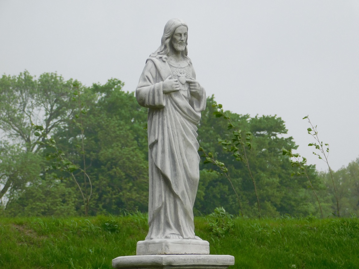 Sacred Heart statue on pedestal - solid stone