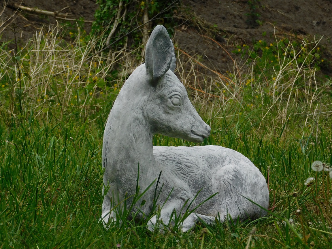 Statue of a deer lying down - solid stone