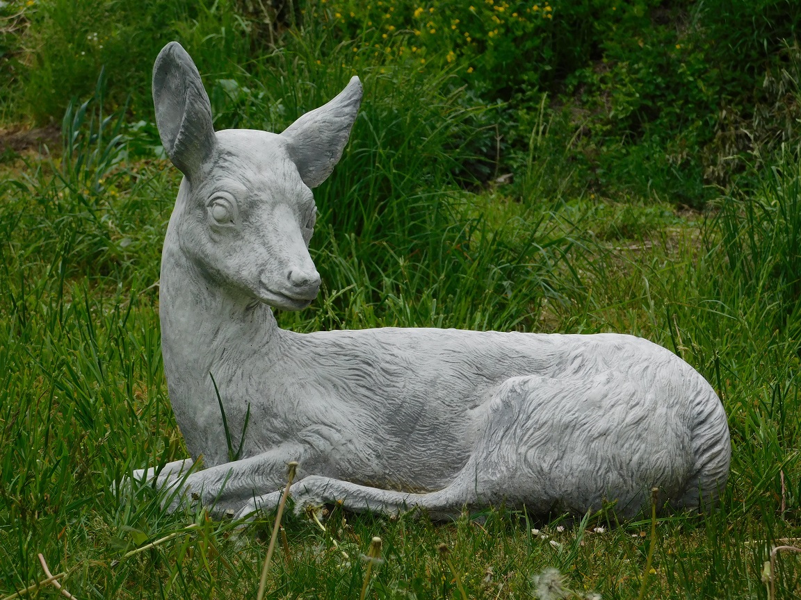 Statue of a deer lying down - solid stone