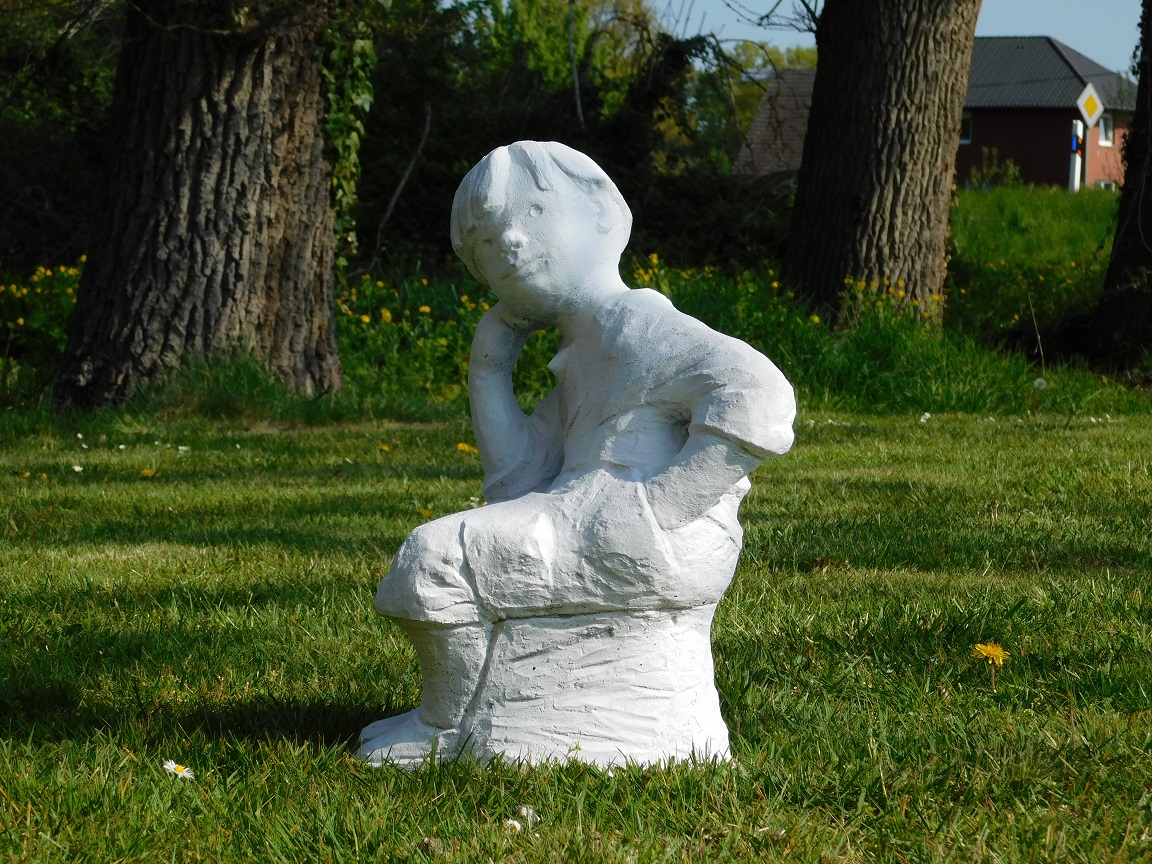 Statue sitting boy - solid stone