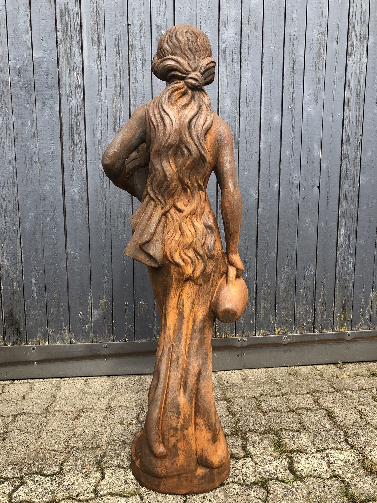 Beautiful oxidised stone sculpture of a standing woman with a water jug