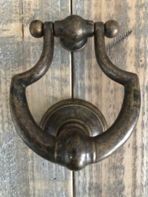 Door knocker, stylish and antique dark brass.