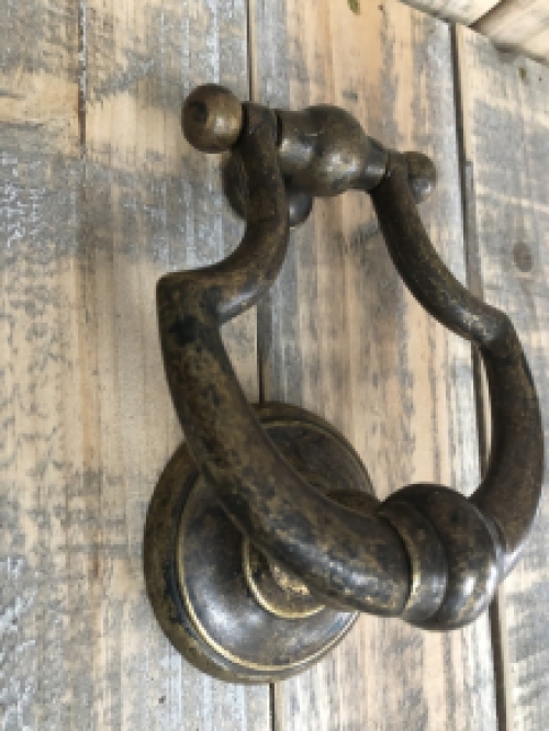 Door knocker, stylish and antique dark brass.