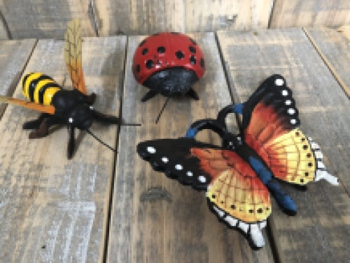 Cast iron figurines of a bee, butterfly and ladybird, full of colour.