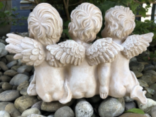 3 angels sitting in 1 row, very beautiful statue.