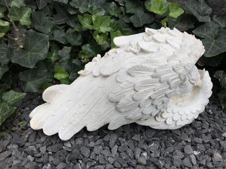 Statue of an angel sleeping in his wings, made of polystone