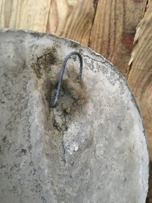 Wall ornament stone round, with an image of the cheerful oak leaf man, forest spirit.