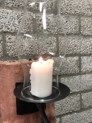 Wind light of roof tile with mythical image, with candlestick and glass flask.