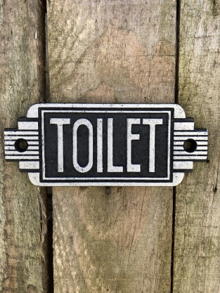 Cast iron sign ''Toilet'' in front of door