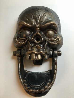 Cast iron bronze skull as door knocker.