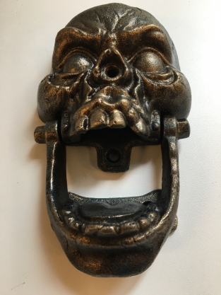 Cast iron bronze skull as door knocker.
