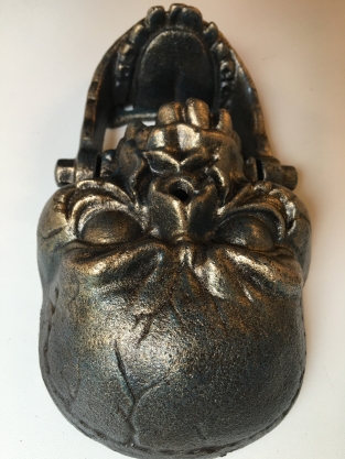 Cast iron bronze skull as door knocker.