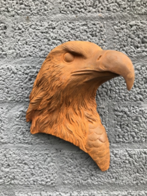 Eagle's head, cast iron wall ornament with rustic surface