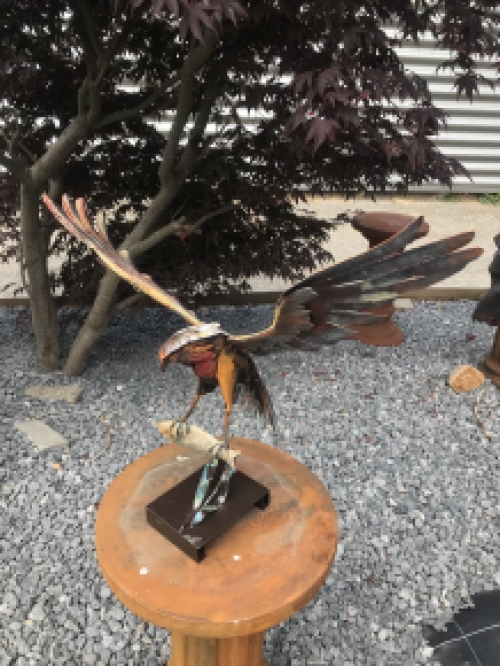 A metal artwork of an eagle catching a fish, ''IRON EAGLE''