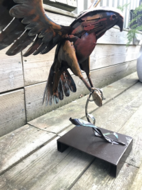 A metal artwork of an eagle catching a fish, ''IRON EAGLE''