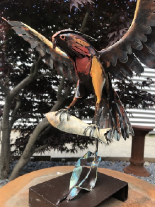 A metal artwork of an eagle catching a fish, ''IRON EAGLE''