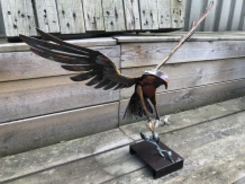 A metal artwork of an eagle catching a fish, ''IRON EAGLE''