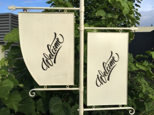 Welcome sign metal on stand, wrought iron white