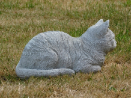 Statue of a lying cat - made entirely of stone - garden statue