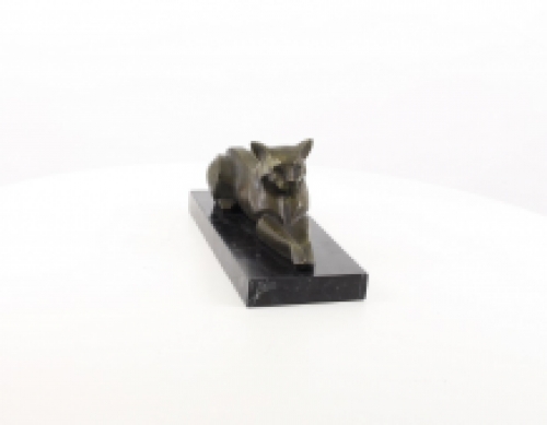 A bronze statue/sculpture of a lying cat, modernist style