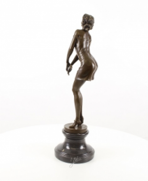 A bronze statue/sculpture of a pensive woman