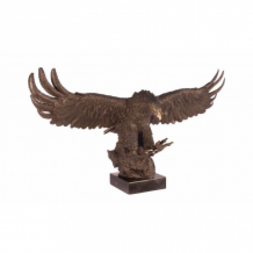 A bronze statue/sculpture of a descending eagle