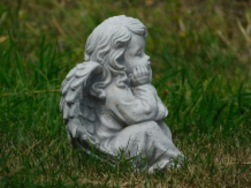 Angel sitting full of stone, beautiful in detail.