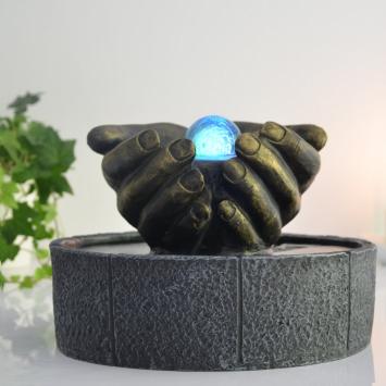 Indoor fountain, hands as bowl, illuminated water ornament