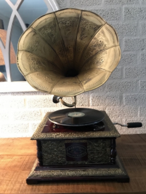 Graceful nostalgic gramophone, record player made of brass and wood