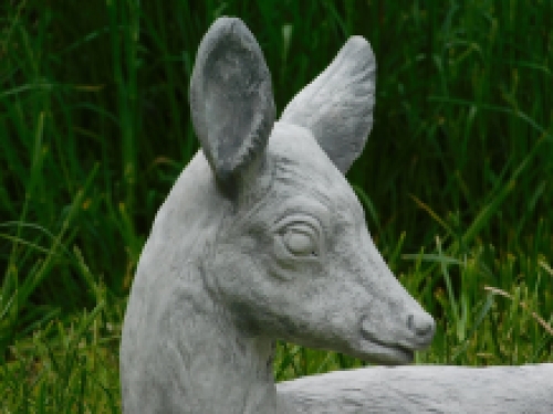 Statue of a deer lying down - solid stone