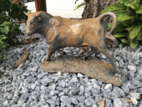 A beautiful statue of a bull, cast iron rest