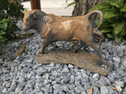 A beautiful statue of a bull, cast iron rest