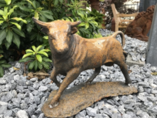 A beautiful statue of a bull, cast iron rest