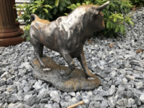 A beautiful statue of a bull, cast iron rest