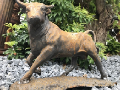 A beautiful statue of a bull, cast iron rest