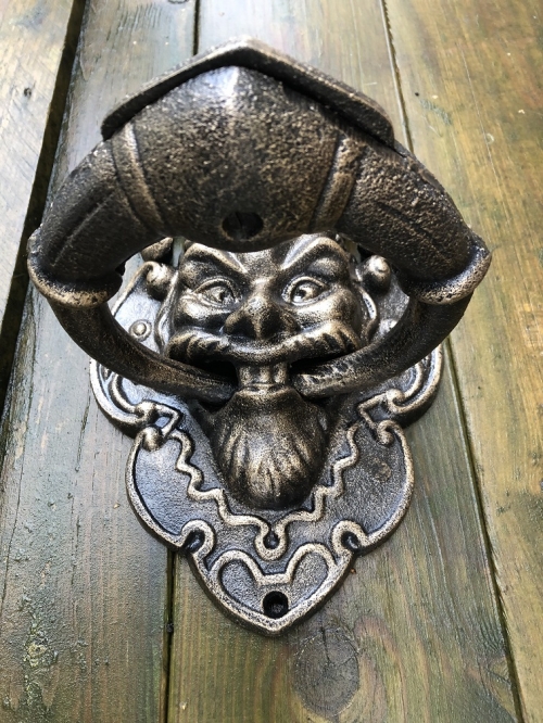 Cast iron bronze door knocker with devil's head.