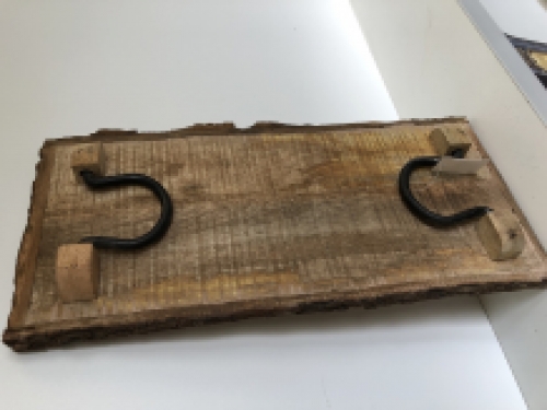 Beautiful rustic cutting board made of solid wood, nostalgic kitchen board, with metal brackets.