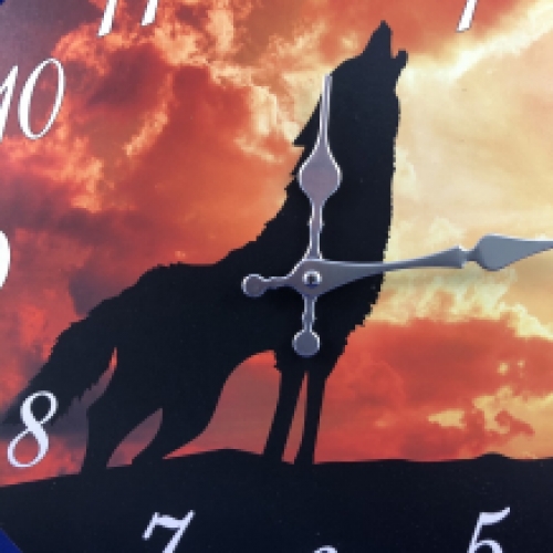 Wooden clock with image of a wolf.