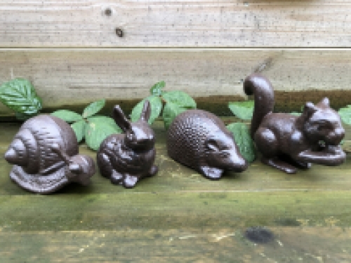 Set of beautiful cast iron animal statues: snail, rabbit, hedgehog and a squirrel.