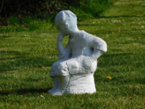 Statue sitting boy - solid stone