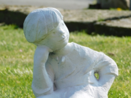 Statue sitting boy - solid stone