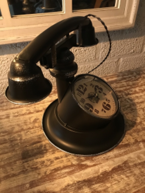 Nice clock in the shape of an old telephone, nostalgic!