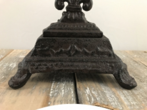 A cross on a stand made of cast iron