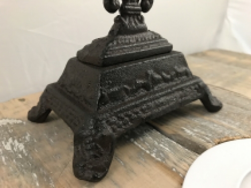 A cross on a stand made of cast iron