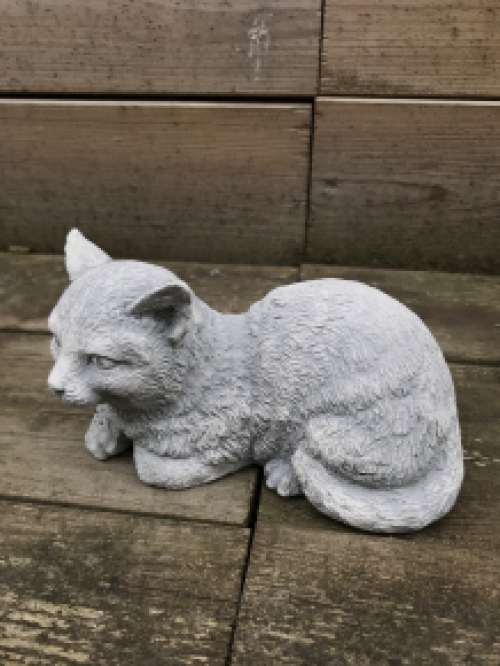A beautiful lying cat, made of stone, beautiful in detail