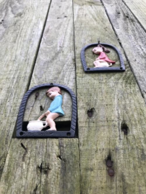 Set of toilet signs of a boy and a girl, metal in color