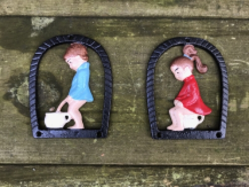 Set of toilet signs of a boy and a girl, metal in color